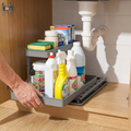 Hand sliding out the under-sink pull-out organizer drawer